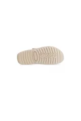 Zuecos de lana de cordero color beige con detalles en cuero nobuck. Presentan una correa ajustable con cierre de velcro sobre el empeine, forro interno de lana suave para mayor calidez y suela de poliuretano liviana. Diseño versátil inspirado en el estilo escandinavo, apto para uso tanto en interiores como en exteriores.