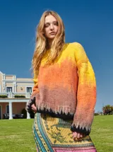 Sweater tejido multicolor con degradé de amarillo a naranja y marrón, con cuello redondo y terminaciones en punto elástico negro.