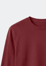 Camiseta básica de manga larga con cuello redondo, confeccionada en tejido de algodón liso.