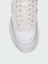 Zapatillas Moncler modelo Pacey de color negro, con diseño de caña baja y suela dentada. Presentan detalles en gamuza y nylon, y una presilla trasera con los colores tricolores de la marca.
