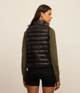 Chaleco puffer deportivo negro, ultraligero, con cuello alto y cierre frontal con cremallera. Incluye bolsita para guardarlo.