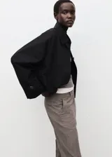 Pantalón de vestir gris con diseño sutil de cuadros, tiro medio y corte recto al tobillo.