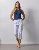 Pantalón capri blanco de gabardina elastizada. Pretina ancha elastizada, delantera con bolsillos simulados y trasera con bolsillos aplicados.