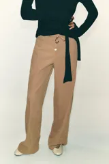 Pantalón blanco de tiro alto con pierna ancha y cordón ajustable en la cintura. Presenta bolsillos laterales y falsos bolsillos de vivo en la parte trasera.