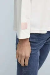 Remera celeste de corte holgado con mangas anchas y estampado de estrella roja en el pecho y logo en la manga.