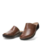 Zuecos de cuero negro con diseño de punta cerrada y suela de plataforma baja con costuras visibles.