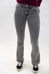 Jeans tiro alto de denim negro, diseño ajustado en la cintura y los muslos, con corte acampanado desde la rodilla hacia el dobladillo.