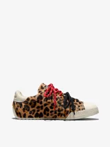 Championes Converse Chuck Taylor Low con exterior de pelo con estampado animal print de leopardo, puntera de goma blanca, y doble juego de cordones en color rojo jaspeado y negro.