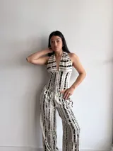 Pantalón de pierna ancha con estampado de rayas verticales negras sobre fondo crudo, confeccionado en tela slab con cintura elástica.