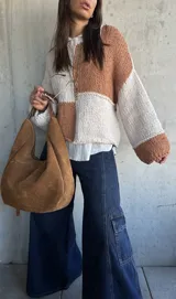 Sweater de punto con diseño de bloques de color en tonos camel y crudo, de corte holgado, cuello redondo y mangas largas con puños anchos.