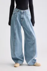 Jean balloon de tiro alto, confeccionado en denim rígido color celeste, con costuras verticales expuestas en el frente y perneras amplias.
