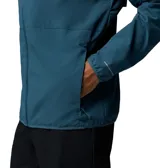 Campera cortaviento Columbia Trailborne Jacket Omni-Shield, color azul, con capucha incorporada, cierre frontal y bolsillos laterales con cremallera. Incorpora tecnología repelente a la humedad y manchas.