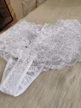 Conjunto de lencería compuesto por un top de encaje con mangas cortas y escote profundo, y una bombacha tipo hipster de encaje completo.