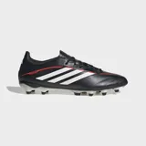 Championes de fútbol Adidas Copa Pure IV League para terreno firme. Diseño en color negro con las icónicas tres tiras blancas laterales y detalles en rojo. Presentan tecnología FUSIONFEEL para mayor comodidad y tracción optimizada.