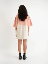 Remerón de corte oversize con diseño bicolor en tonos rosado y blanco hueso, de manga corta y cuello redondo.