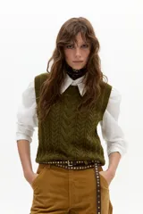 Chaleco de punto color verde militar, con cuello a la base, diseño de ochos en el frente y terminaciones de rib.