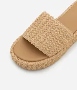 Sandalia flatform de Satinato color beige, con suela plana de plataforma y tira ancha superior con textura trenzada.