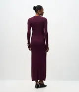 Vestido midi de punto acanalado color bordó, con cuello redondo y mangas largas. Presenta un diseño ajustado en el torso que se extiende hacia una falda con caída fluida.