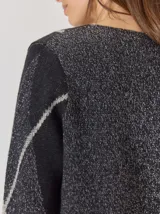 Buzo de lana con escote en V, diseño de rombos y detalles en hilo metalizado. Presenta mangas largas y corte holgado.