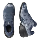 Calzado de trekking Salomon modelo Speedcross 6, en tonos gris y verde claro, diseñadas para trail running con suela de gran tracción y cordones de ajuste rápido.