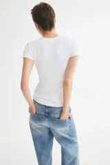 Remera entallada de microfibra, color blanco, de manga corta y cuello redondo fino ribeteado.