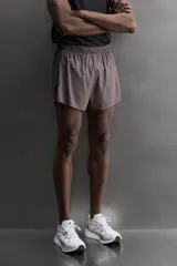 Short de running confeccionado en tejido técnico ligero y elástico con estructura. Cuenta con forro interior, cintura elástica ajustable con cordón, bolsillo trasero con cierre oculto, bolsillos laterales multifunción y aberturas laterales en las perneras.