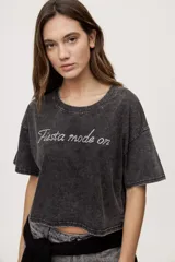 Remera gris de fit amplio, con mangas cortas y cuello redondo. Presenta efecto lavado y estampa frontal con aplicación de strass con la frase "fiesta mode on".