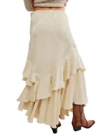 Falda maxi color verde oliva con diseño floral jacquard, corte asimétrico y múltiples volantes en el ruedo. Presenta un detalle de lazo lateral y cintura elástica.