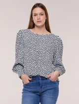 Blusa de manga larga abullonada con estampa geométrica en blanco y negro, escote redondo y puños anchos.