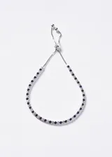 Pulsera de plata 925 tipo tennis con cierre ajustable slider, decorada con circones transparentes y azules intercalados.