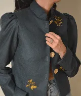 Chaqueta corta azul marino de terciopelo con cuello mao, botones dorados y bordado floral en el frente.