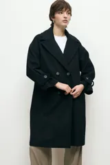 Abrigo de paño de lana con cuello alto estructurado, cierre frontal y mangas largas con detalle de botón en el puño.
