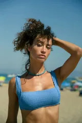 Conjunto de bikini celeste de lycra texturizada, compuesto por un corpiño de corte cuadrado con breteles anchos fijos y una bombacha vedetina.