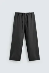 Pantalón de corte regular fit confeccionado en mezcla de algodón y lino. Presenta cintura elástica con cordón ajustable, cierre frontal con cremallera y botón, bolsillos laterales y bolsillo trasero de vivo con botón.
