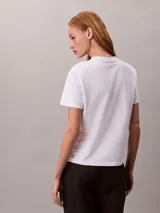Remera Calvin Klein de manga corta color blanco, confeccionada en algodón, con cuello redondo y el logo de la marca en acabado metalizado en el pecho.