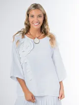 Remera oversized confeccionada en lino italiano color blanco, con aplique tridimensional de flor en el mismo lino.