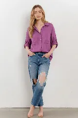 Camisa de lino color fucsia, con cuello camisero, botones frontales, dos bolsillos en el pecho y mangas 3/4 con presilla y botón.