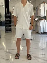 Bermuda blanca de tejido texturizado, con pequeño bordado oscuro en la parte inferior izquierda.