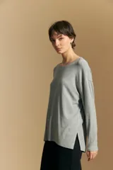 Remera de manga larga con silueta relajada y caída fluida, confeccionada en tejido suave con cuello redondo y aberturas laterales en el ruedo.