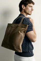 Bolso shopper vertical confeccionado en piel con acabado serraje, color verde militar, con compartimento principal y dos asas de hombro.