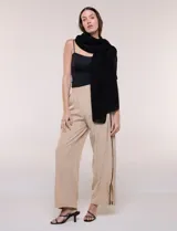 Pashmina rectangular negra confeccionada en tejido liviano y vaporoso con sutil transparencia y caída fluida, adornada con pequeños apliques de strass.