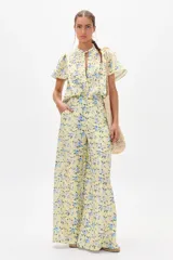 Pantalón de lino con estampado floral en tonos amarillos y azules, de corte palazzo y tiro alto.