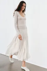 Top de punto extrafino color celeste, con escote redondo y manga larga.