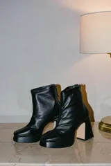 Botines negros de cuero con plataforma y tacón cuadrado.
