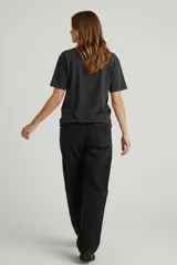 Remera de algodón de manga corta y cuello redondo, con diseño holgado y estampado gráfico frontal con motivos florales y tipografía vintage.