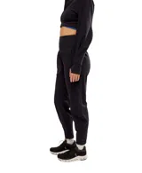 Pantalón de jogging negro de corte holgado, con cintura alta y bolsillos laterales.