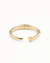 Pulsera rígida abierta bañada en oro, con diseño que simula un clavo, terminando en punta en un extremo y en forma de cabeza de clavo redonda en el otro.