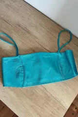 Crop top celeste metalizado con tirantes finos.