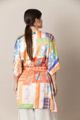 Kimono italiano de satén estampado con motivos geométricos y florales en tonos rojo, azul, naranja y dorado. Incluye lazo de ajuste en la cintura.