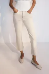 Jeans de tiro alto con cinco bolsillos, diseño cropped flare y bajo sin costuras. Cuenta con cierre frontal de cremallera y botón metálico.